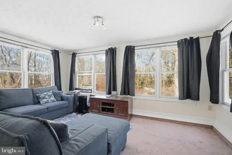 a living room with furniture and large windows