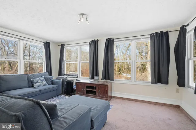 a living room with furniture and large windows