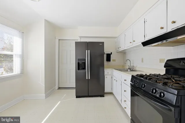 a kitchen with stainless steel appliances granite countertop a refrigerator and a stove