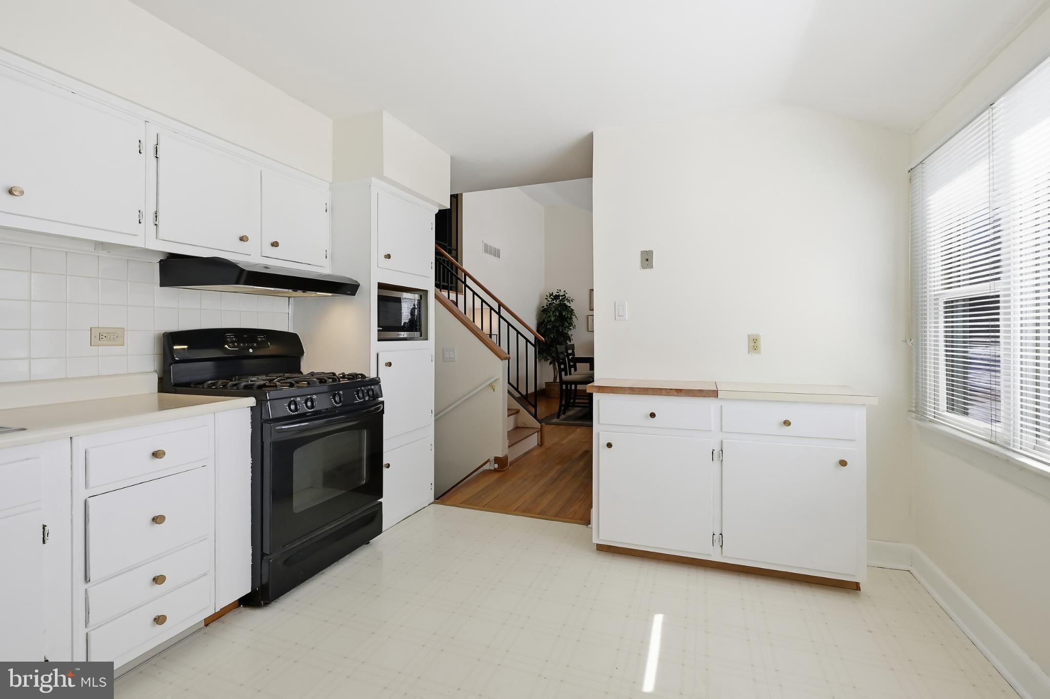 619 Shue Drive Newark, DE 19713 - Photo 9 of 30 a kitchen with white cabinets and white appliances