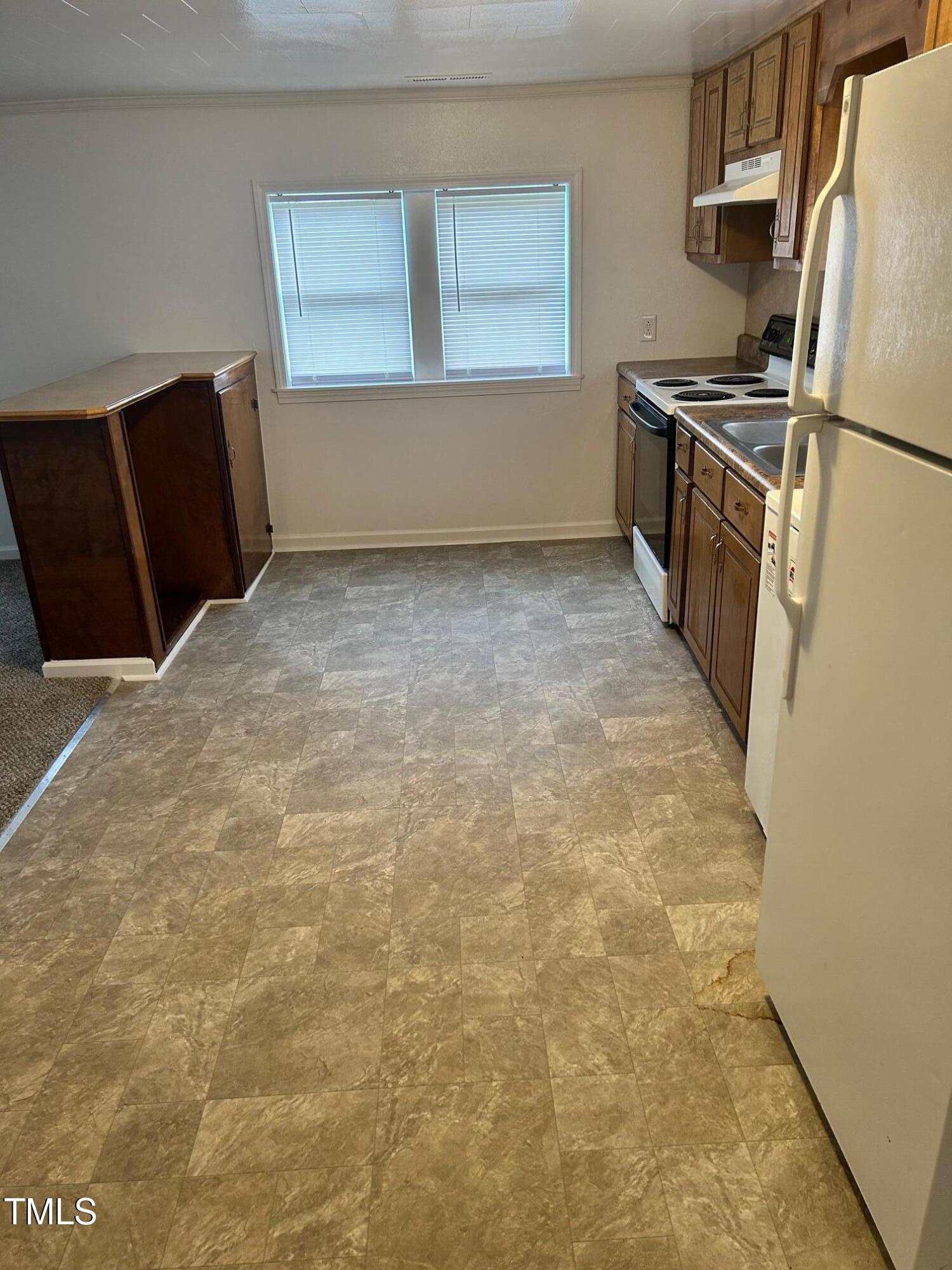 10841 Highway 32 Roper, NC 27970 - Photo 22 of 29 a kitchen with granite countertop a refrigerator and a stove top oven