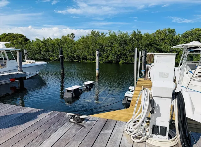 a view of a lake with couches chairs in patio
