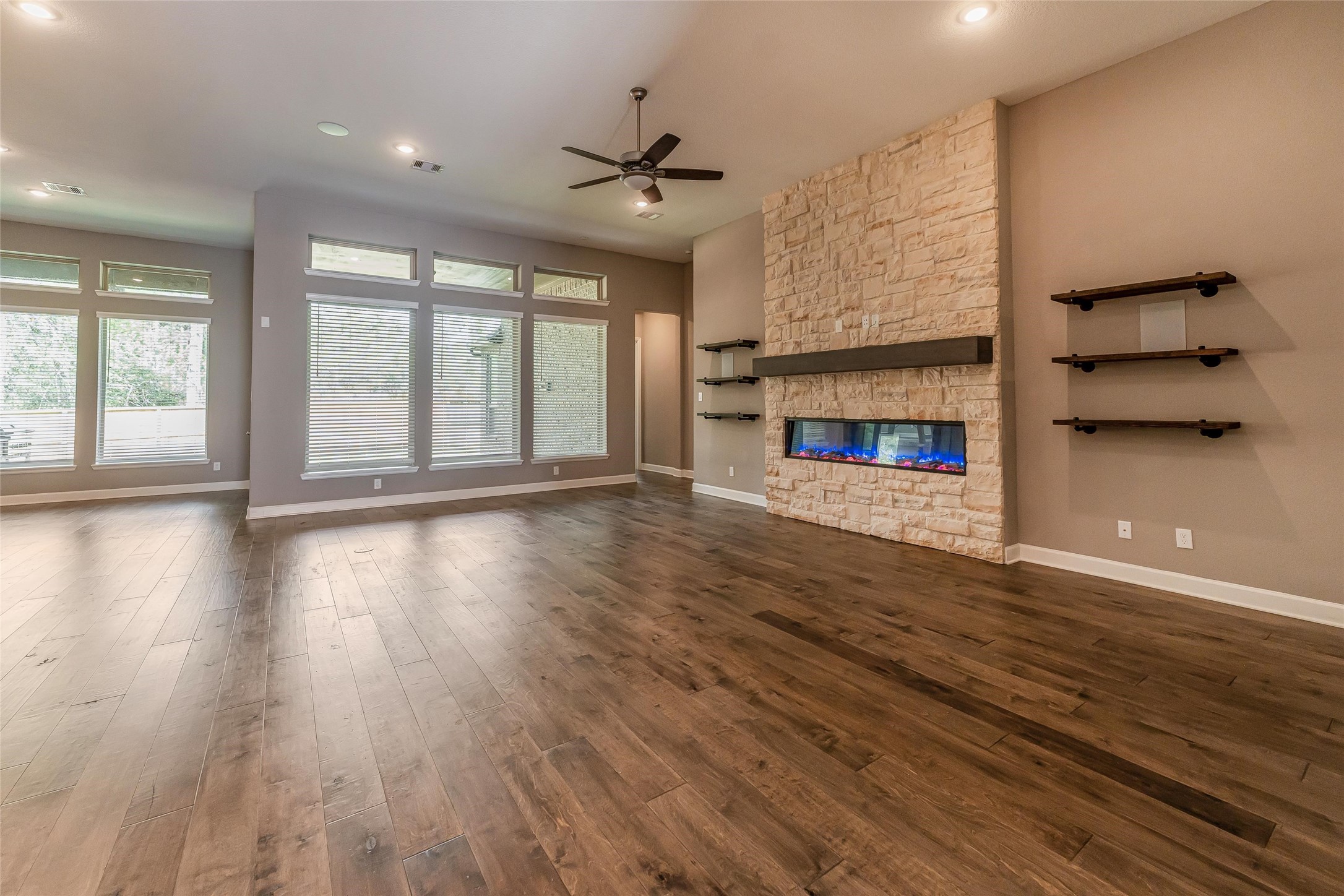 1050 Groveton Ridge Lane Pinehurst, TX 77362 - Photo 13 of 50 an empty room with wooden floor and windows