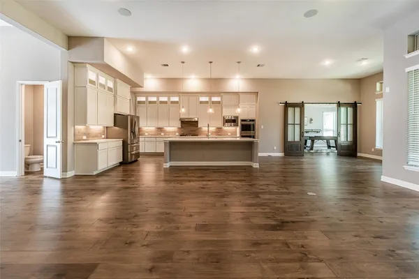 a kitchen with kitchen island granite countertop a sink appliances cabinets and counter space