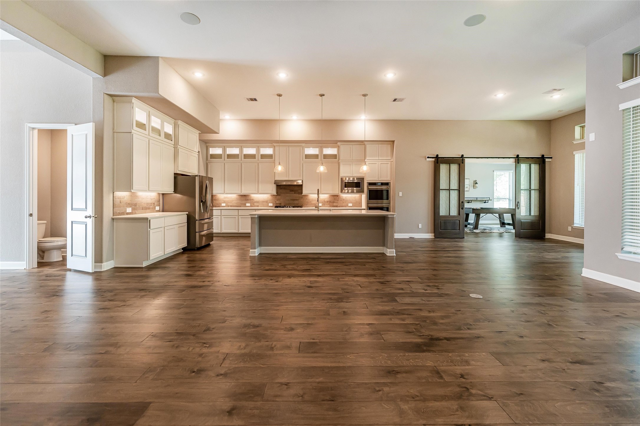 1050 Groveton Ridge Lane Pinehurst, TX 77362 - Photo 16 of 50 a large white kitchen with lots of counter space and stainless steel appliances