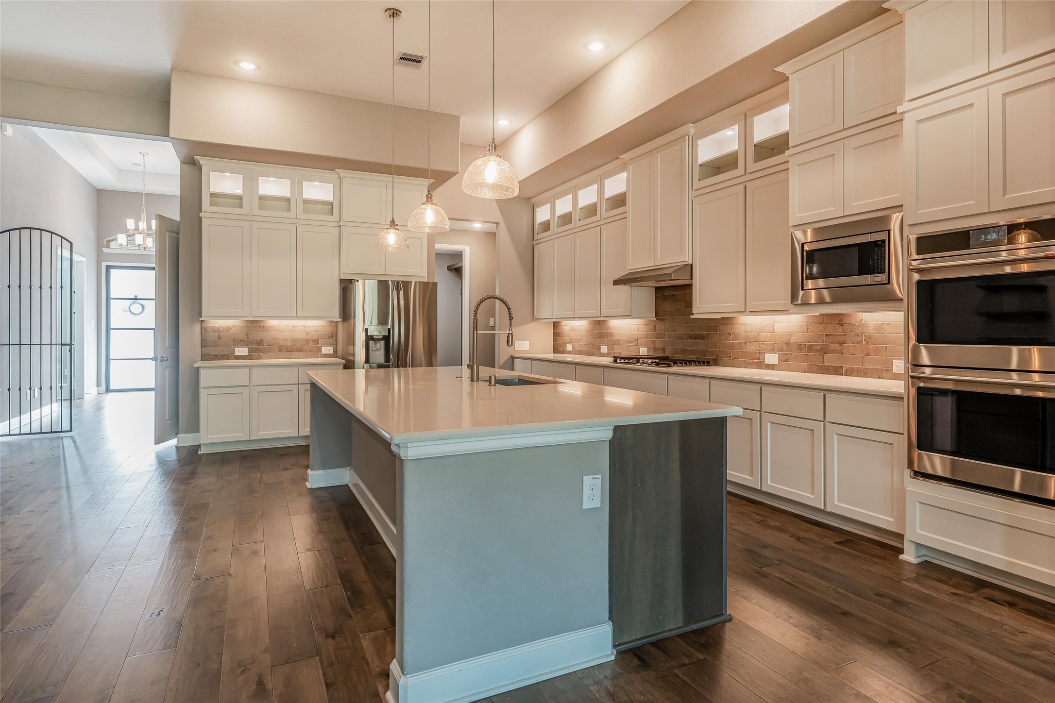 1050 Groveton Ridge Lane Pinehurst, TX 77362 - Photo 19 of 50 a kitchen with stainless steel appliances granite countertop a sink a stove and cabinets