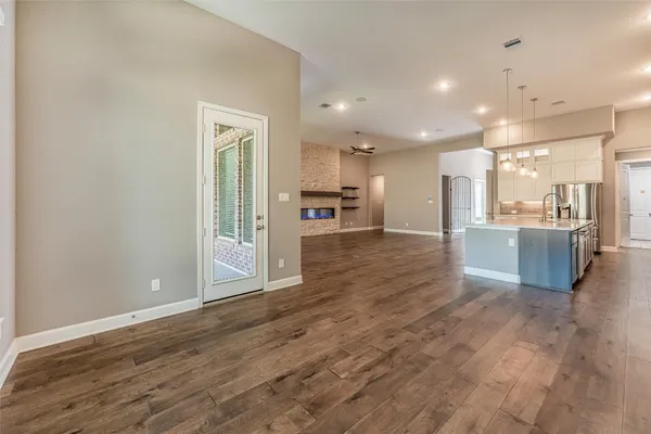 a room with furniture pool table and wooden floor