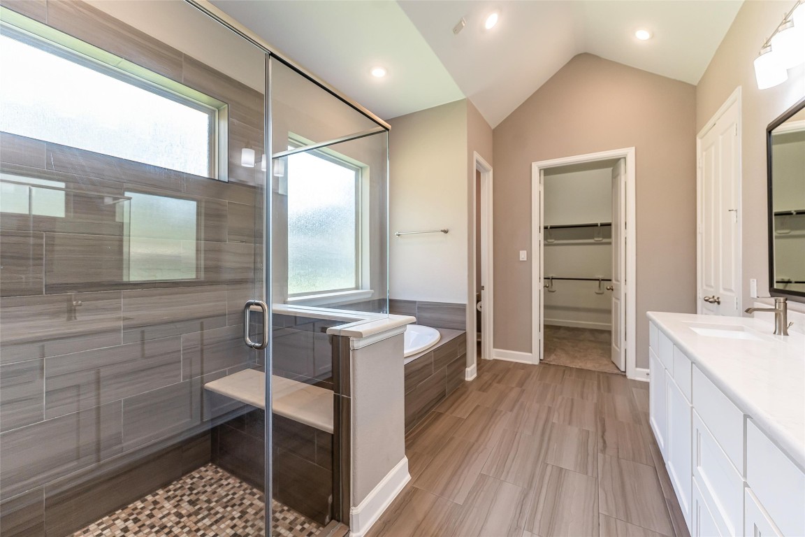 1050 Groveton Ridge Lane Pinehurst, TX 77362 - Photo 31 of 50 Another angle of the primary bathroom with seamless glass shower, soaking tub and quartz counter tops