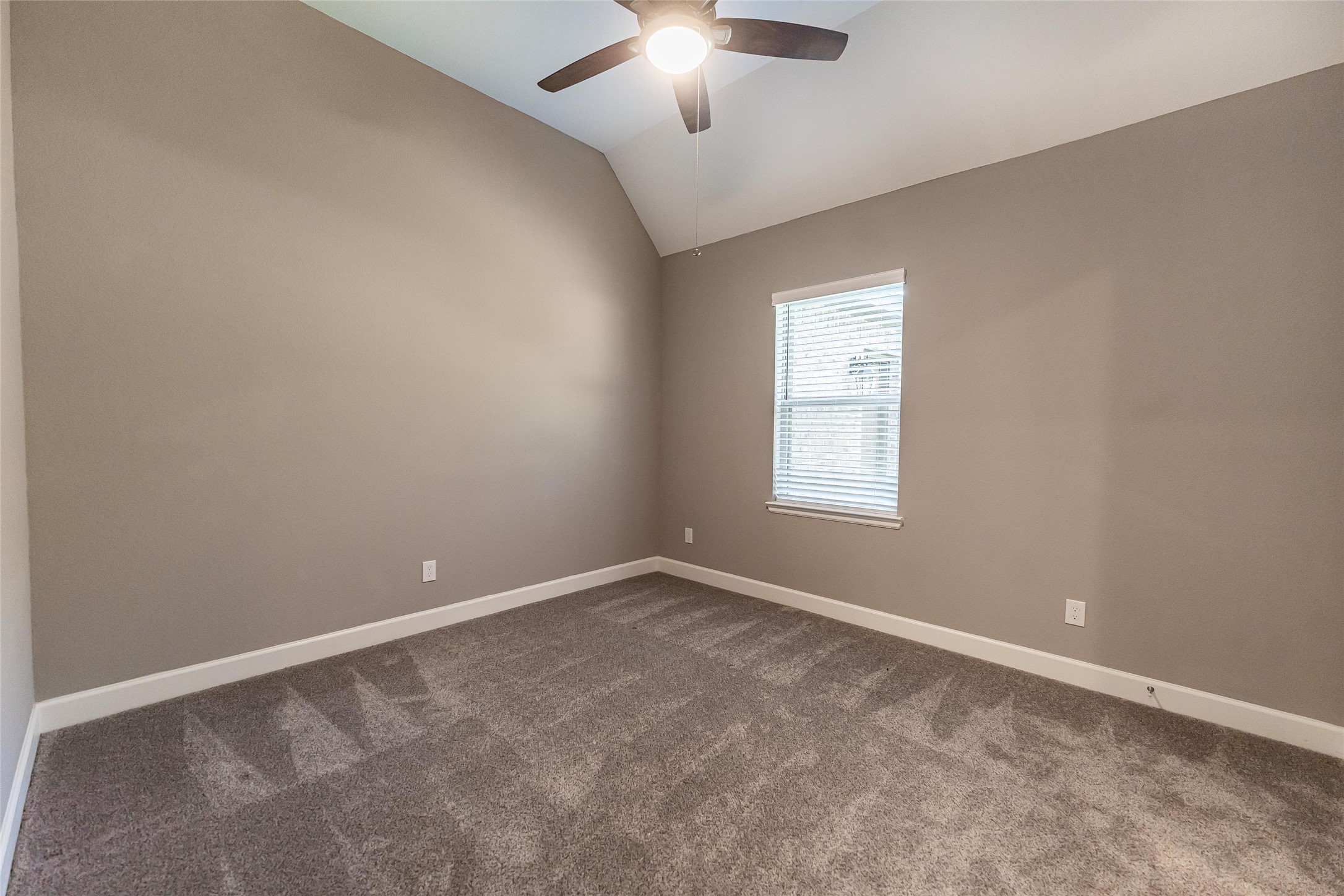 1050 Groveton Ridge Lane Pinehurst, TX 77362 - Photo 35 of 50 an empty room with a chandelier fan and windows