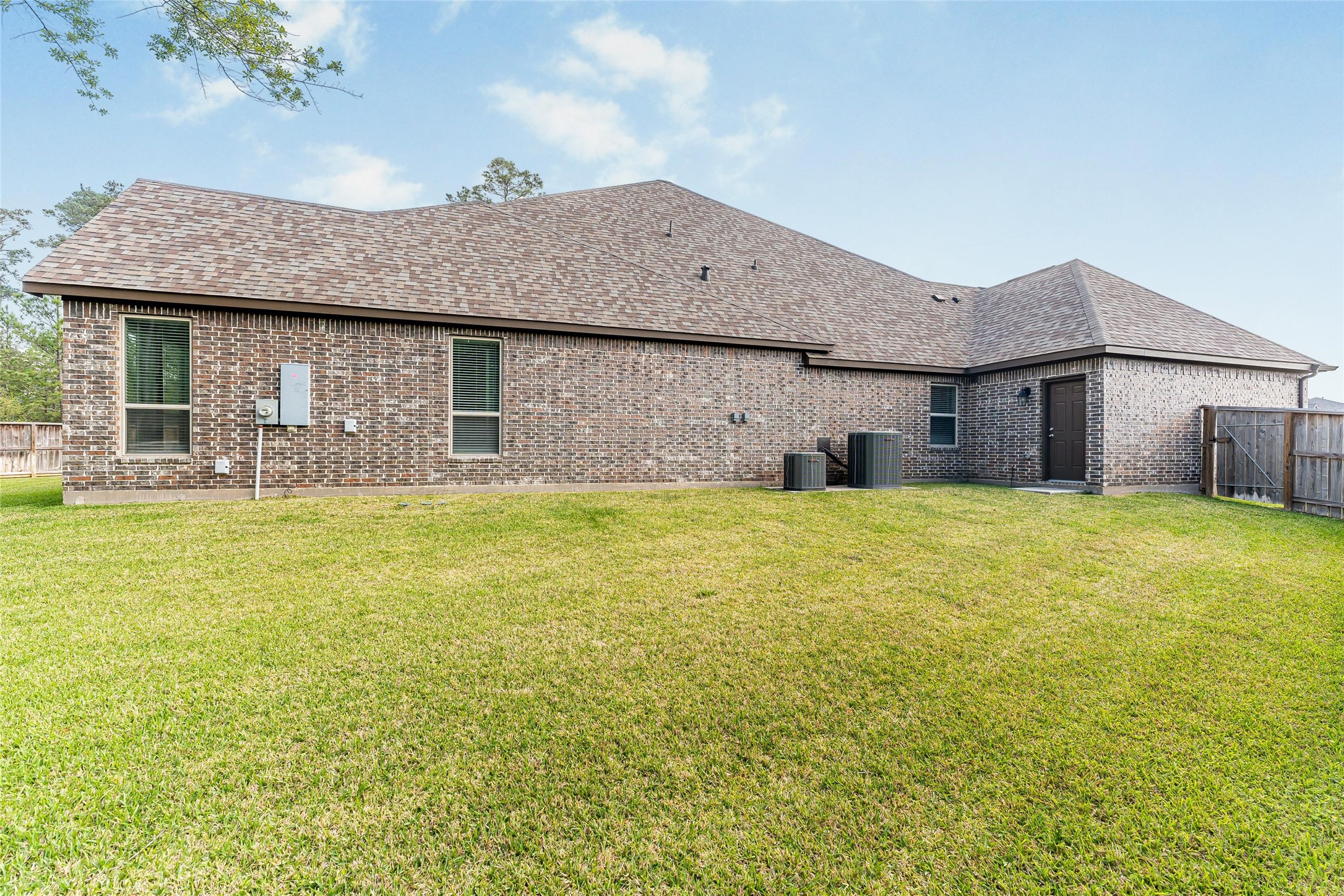 1050 Groveton Ridge Lane Pinehurst, TX 77362 - Photo 43 of 50 a front view of a house with a garden