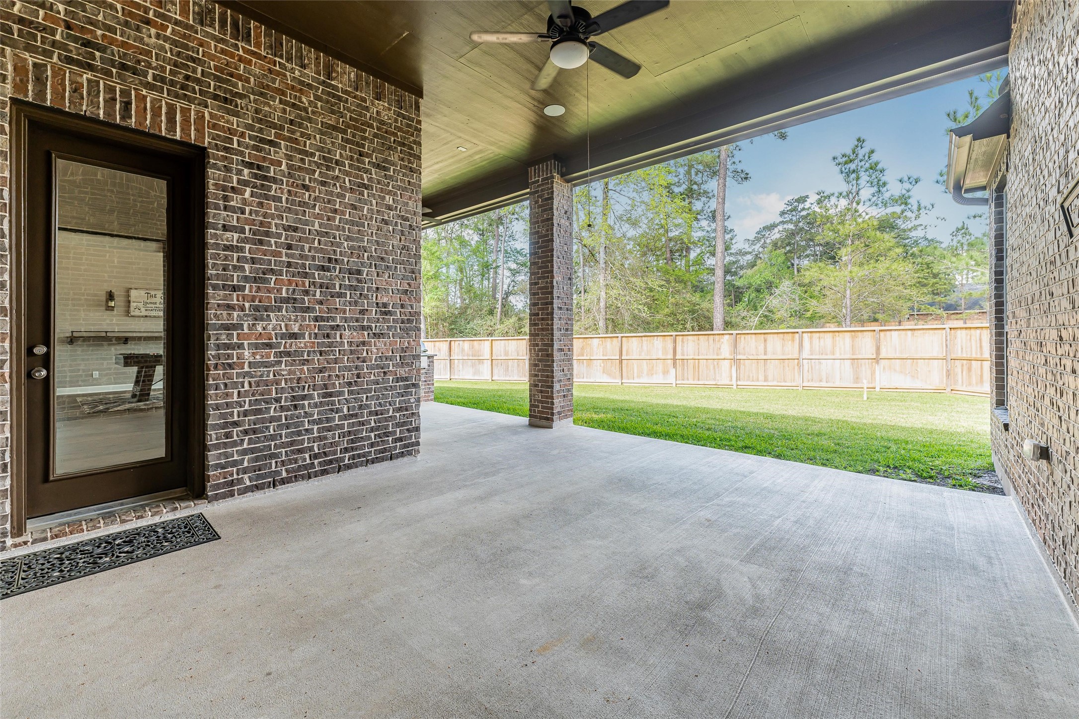 1050 Groveton Ridge Lane Pinehurst, TX 77362 - Photo 47 of 50 a view of a yard with porch and wooden floor