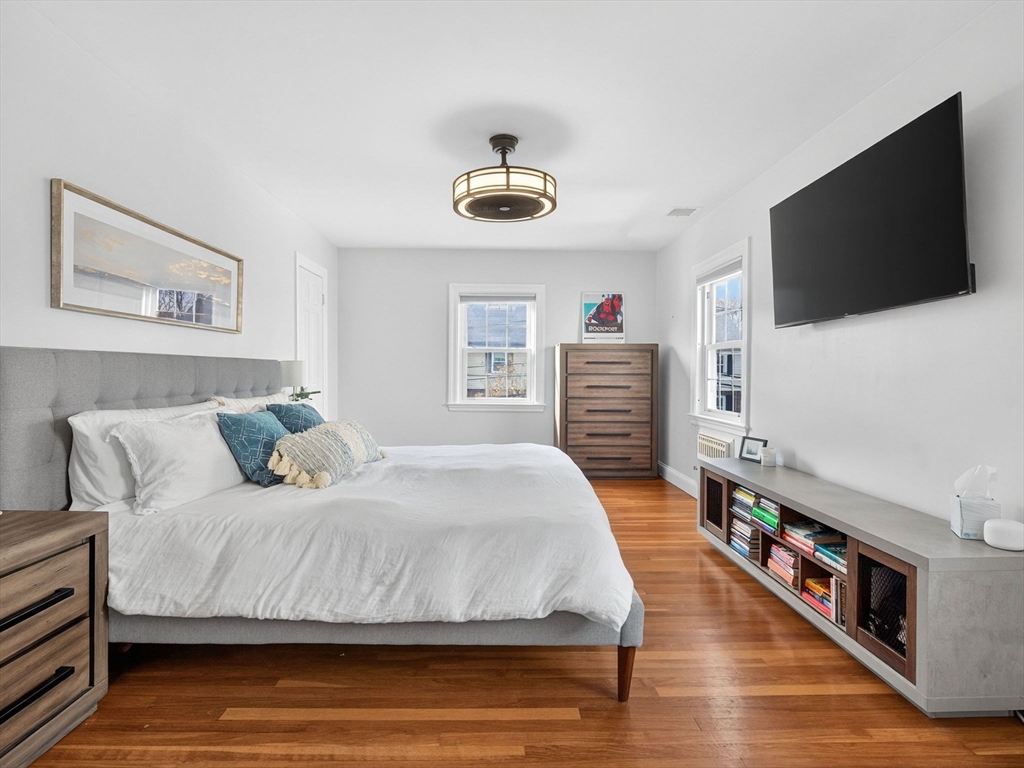 37 Rangeley Street Boston, MA 02124 - Photo 17 of 26 a bedroom with a bed and a flat screen tv