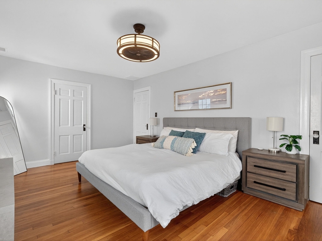 37 Rangeley Street Boston, MA 02124 - Photo 18 of 26 a bedroom with a bed and wooden floor