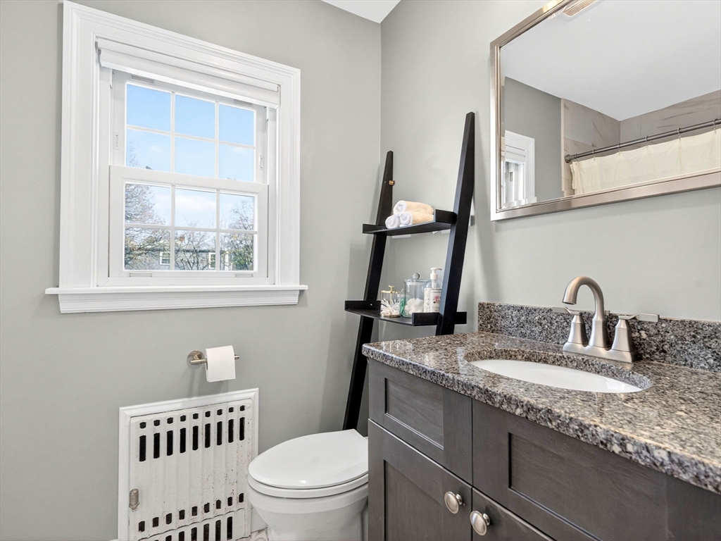 37 Rangeley Street Boston, MA 02124 - Photo 20 of 26 a bathroom with a granite countertop toilet a sink and a window