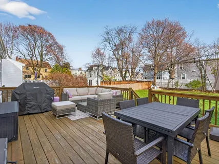 a view of a chairs and table in the back yard of the house