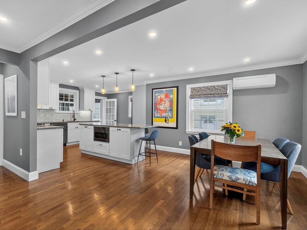 37 Rangeley Street Boston, MA 02124 - Photo 3 of 26 a living room with furniture and a dining table with kitchen view
