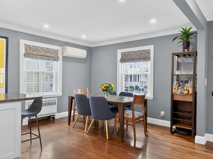 a view of a dining room with furniture window and wooden floor