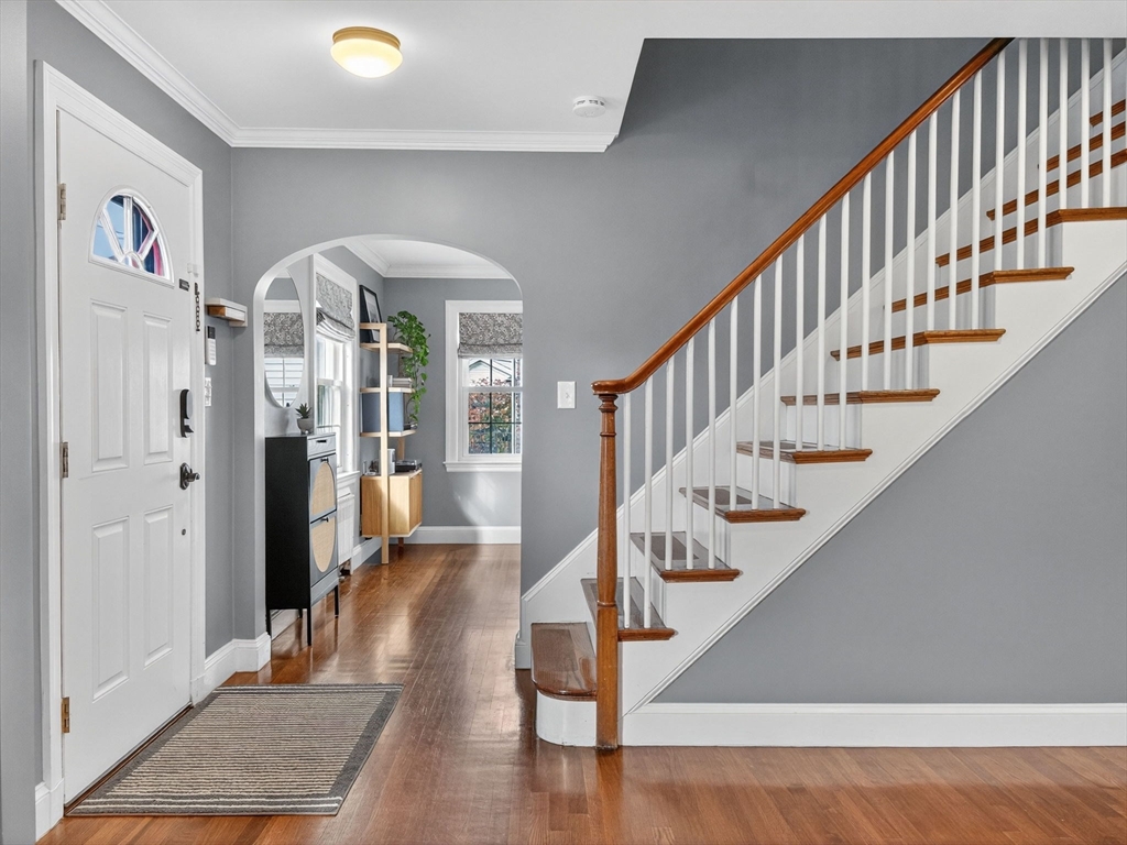 37 Rangeley Street Boston, MA 02124 - Photo 9 of 26 a view of staircase with lots of frames on wall and wooden floor