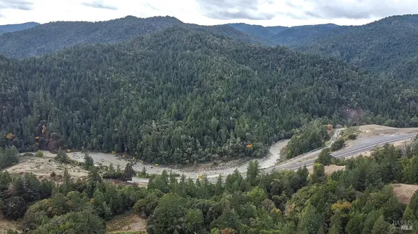 a view of a house with a mountain and a forest