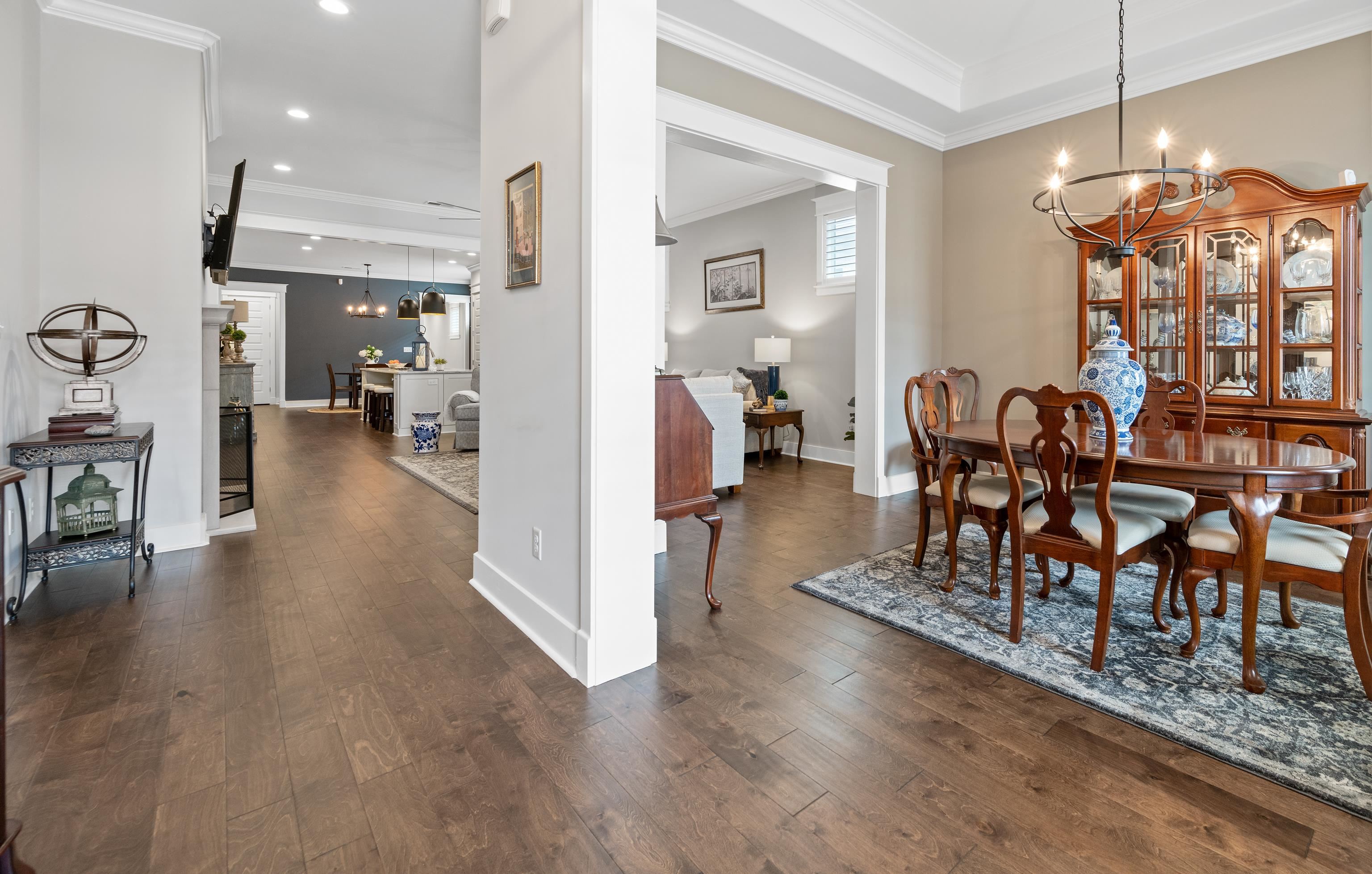 502 South Shea Road Collierville, TN 38017 - Photo 6 of 40 Dining area featuring dark hardwood / wood-style floors, crown molding, and an inviting chandelier