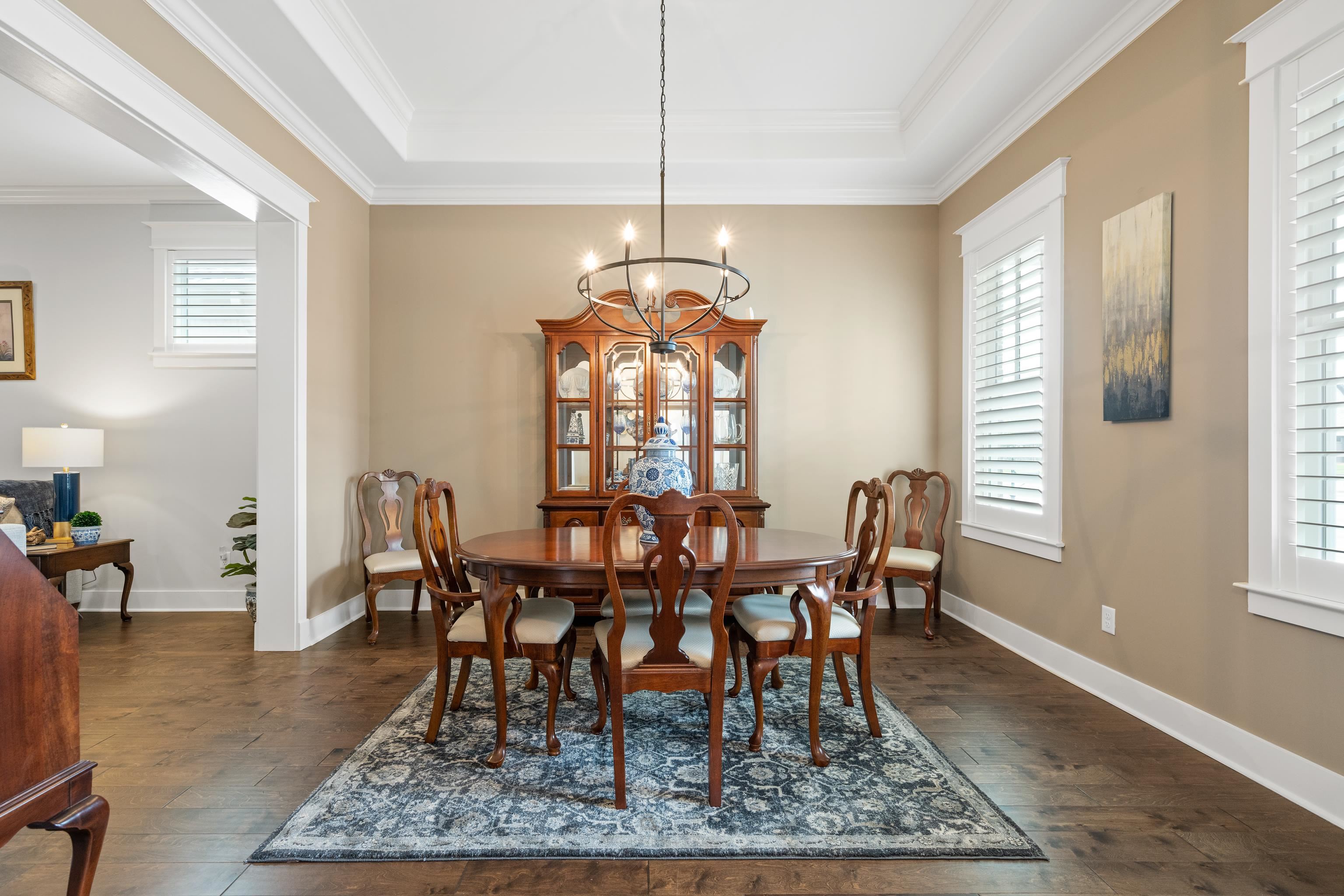 502 South Shea Road Collierville, TN 38017 - Photo 7 of 40 Dining room with dark hardwood / wood-style floors, a notable chandelier, crown molding, and a tray ceiling
