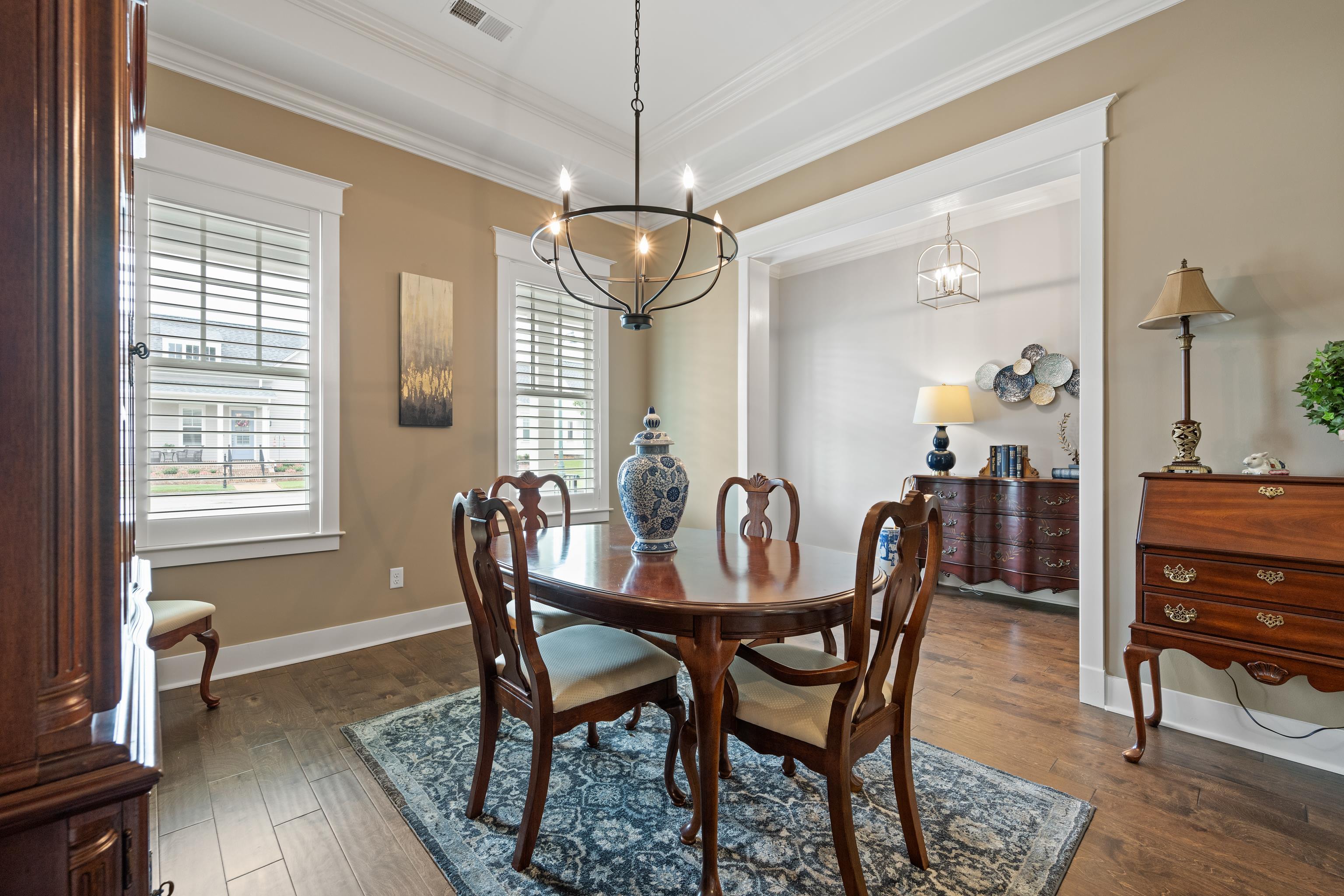502 South Shea Road Collierville, TN 38017 - Photo 8 of 40 Dining room with a tray ceiling, ornamental molding, a chandelier, and dark wood-type flooring