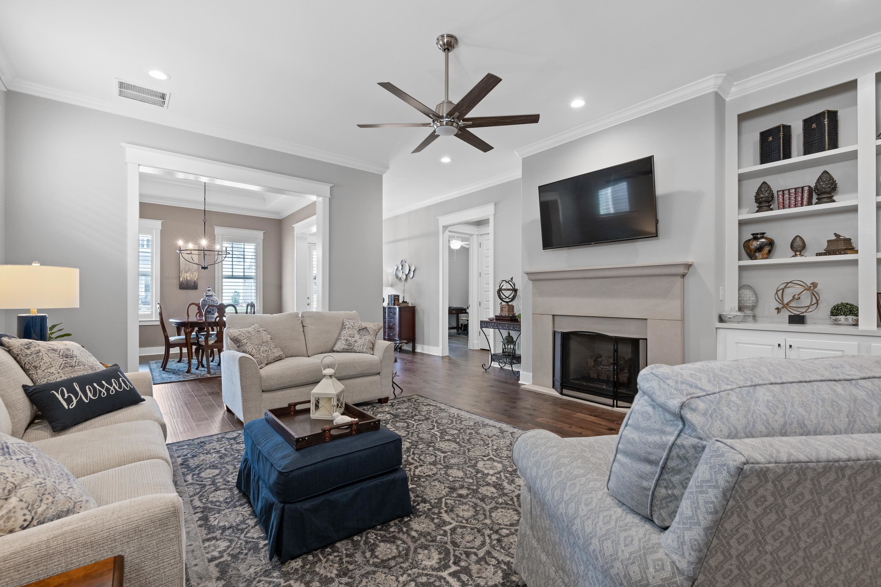 502 South Shea Road Collierville, TN 38017 - Photo 10 of 40 Living room with ceiling fan with notable chandelier, crown molding, and hardwood / wood-style floors