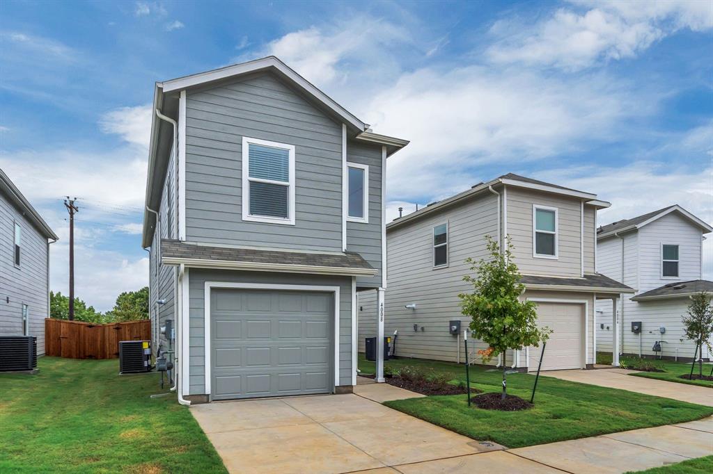 a front view of a house with a garden and yard