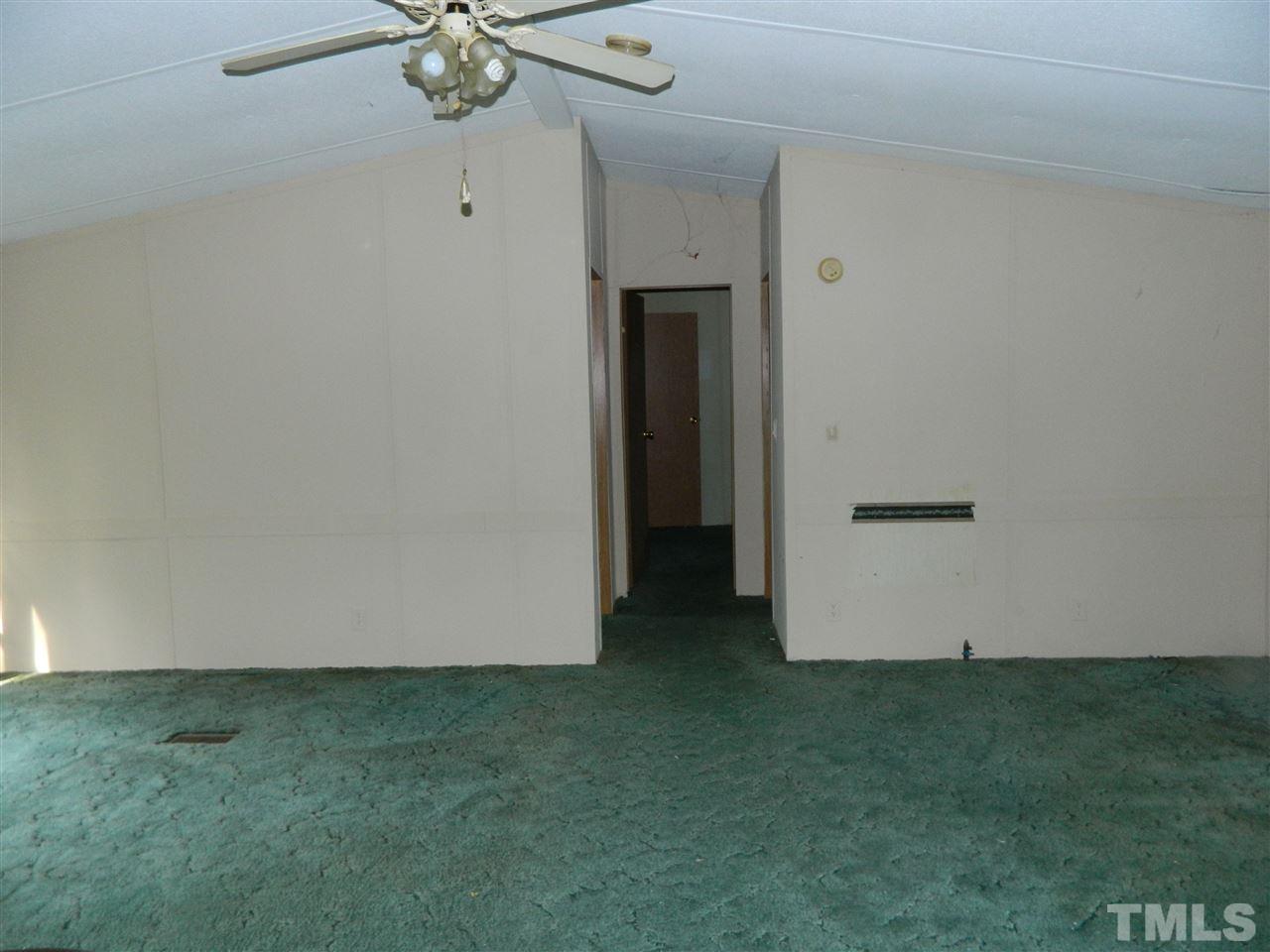 11977 Us 64 A Spring Spring Hope, NC 27882 - Photo 4 of 9 an empty room with closet and a ceiling fan