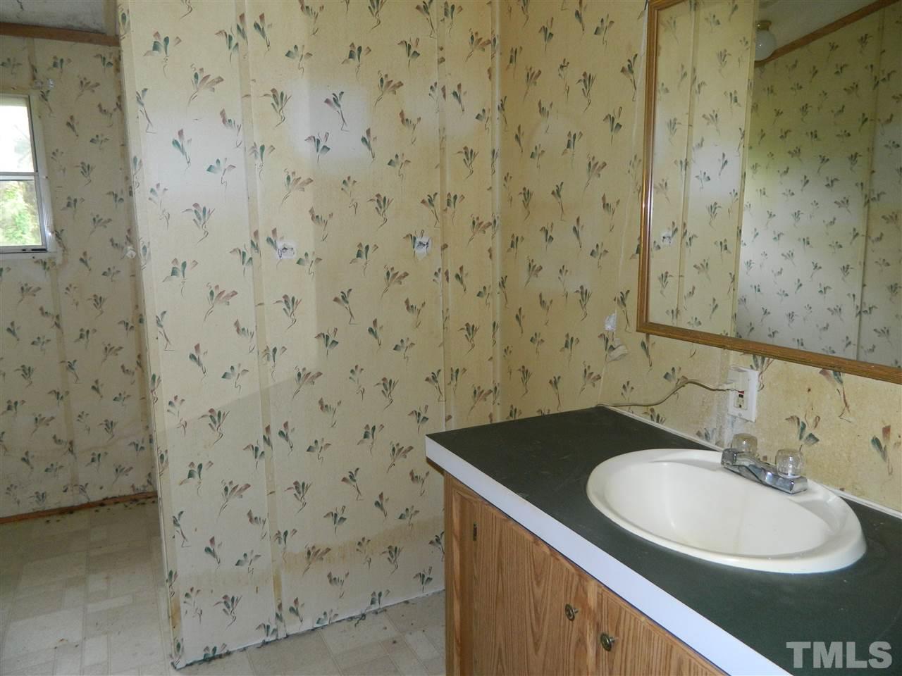 11977 Us 64 A Spring Spring Hope, NC 27882 - Photo 7 of 9 a bathroom with a sink a toilet and a mirror