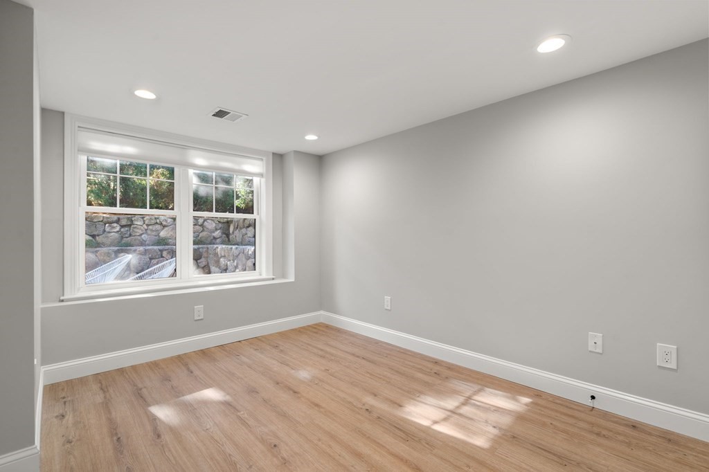 33 Riverside Street, Unit 33 Needham, MA 02494 - Photo 13 of 22 an empty room with wooden floor and windows