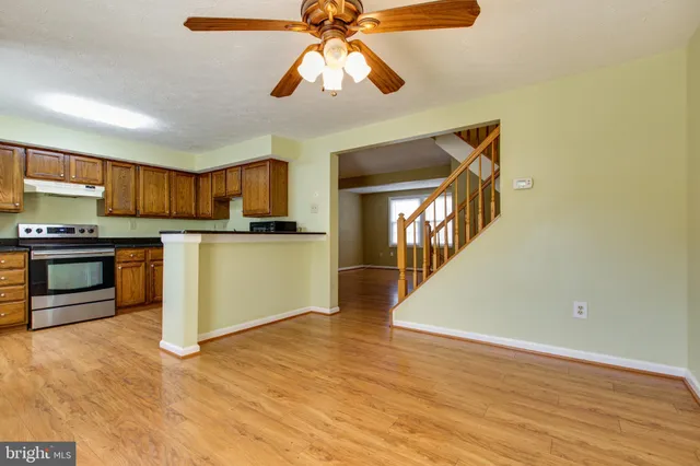 a kitchen with stainless steel appliances granite countertop a refrigerator a stove top oven a sink and dishwasher