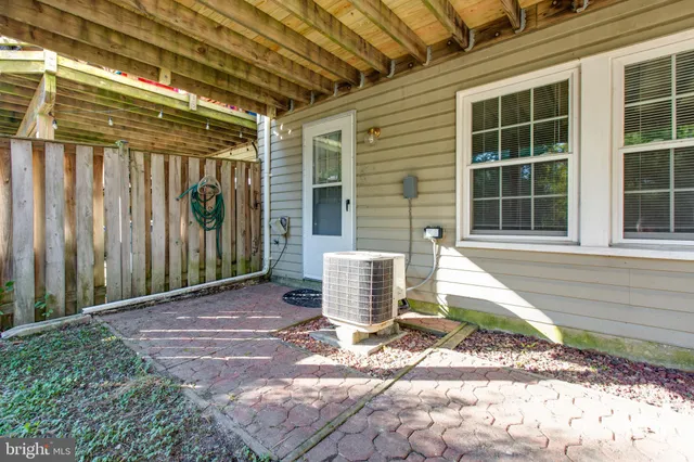 a front view of a house with a floor to ceiling windows and plants