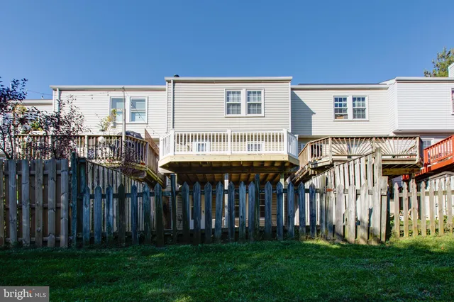 a view of a house with backyard and deck