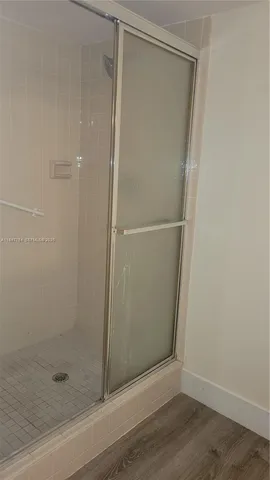 a bathroom with a glass shower door