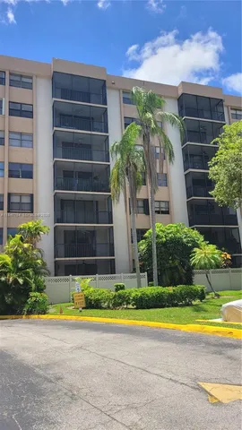 a view of swimming pool with a yard in front of main door