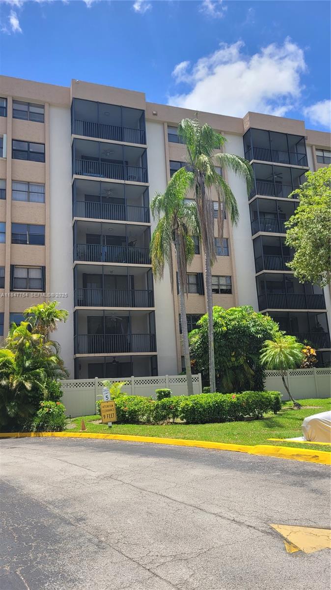 900 Northeast 195th Street, Unit 620 Miami, FL 33179 - Photo 2 of 28 a view of swimming pool with a yard in front of main door