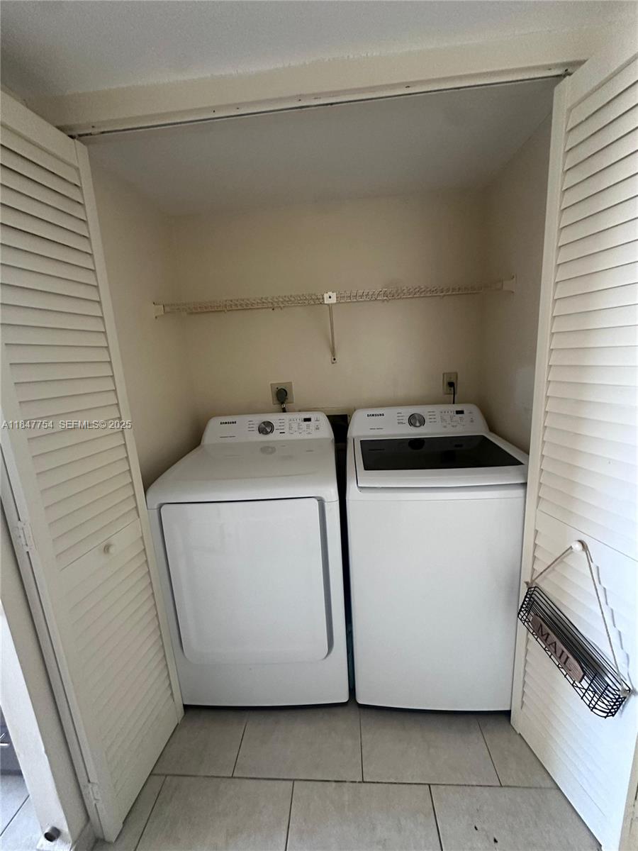 900 Northeast 195th Street, Unit 620 Miami, FL 33179 - Photo 23 of 28 a utility room with dryer and washer