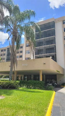 a front view of a house with a yard and a swimming pool