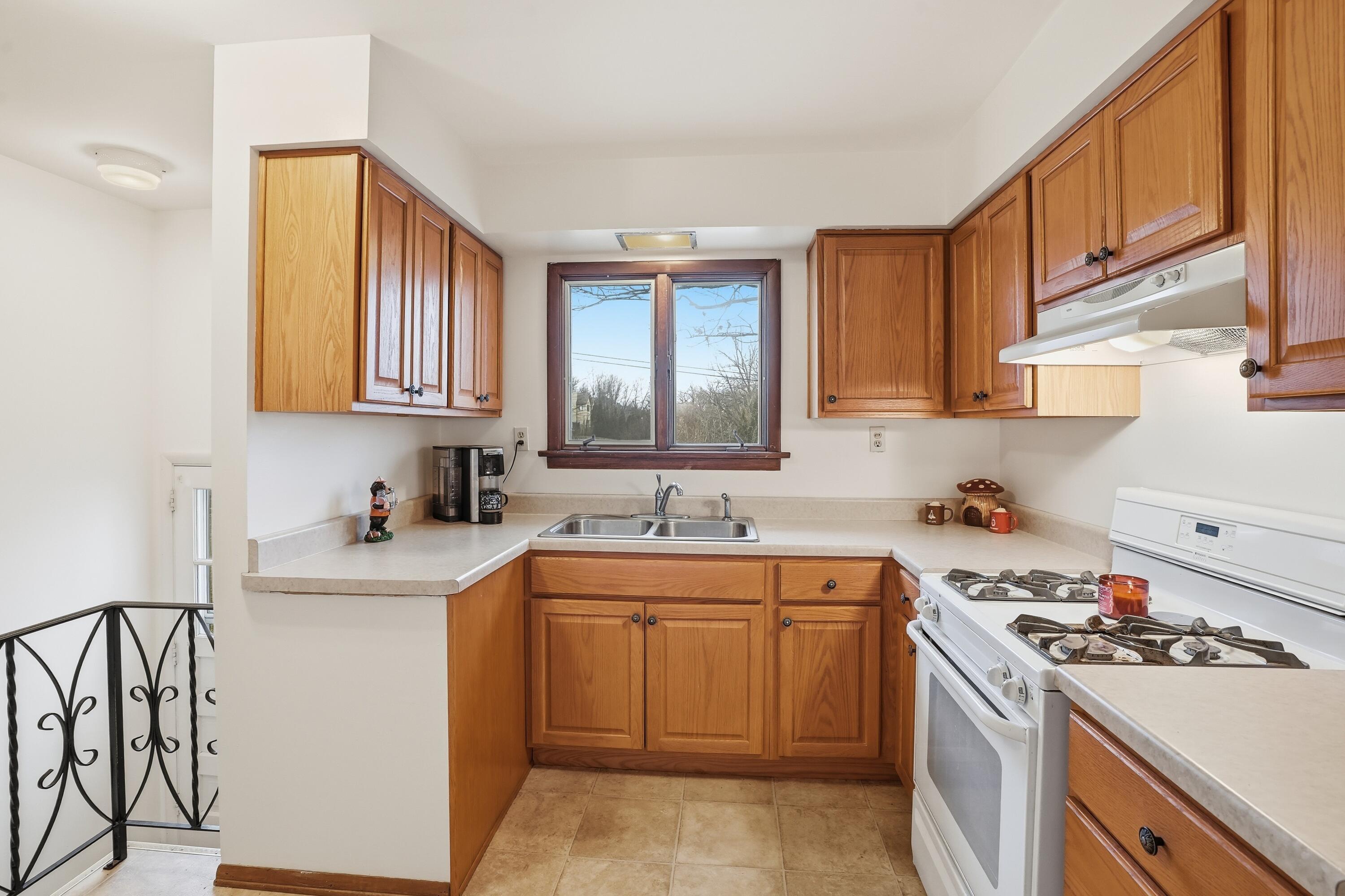 508 West 117th Place Crown Point, IN 46307 - Photo 4 of 20 a kitchen with a sink stove and cabinets