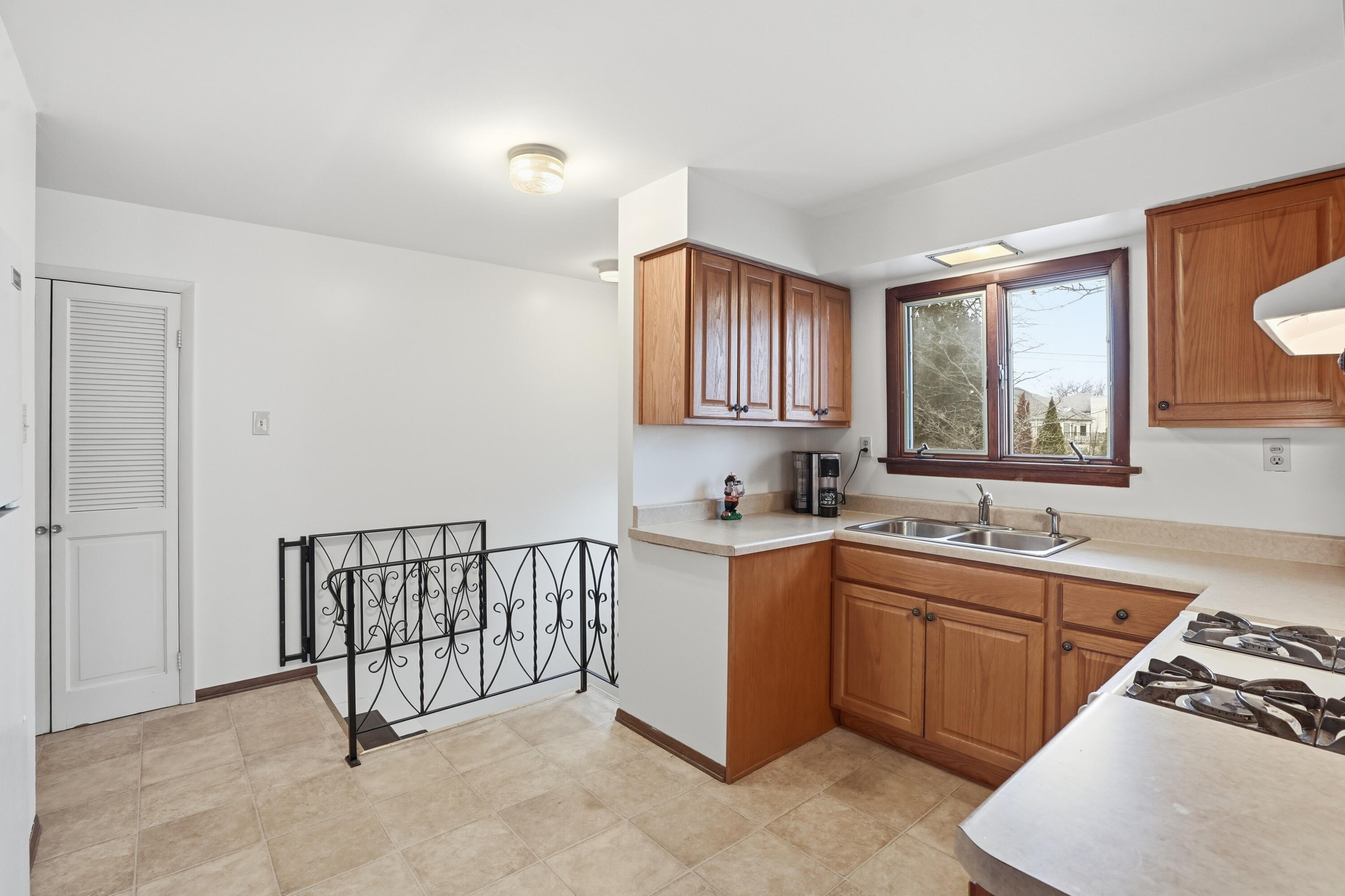 508 West 117th Place Crown Point, IN 46307 - Photo 5 of 20 a kitchen with a sink stove and cabinets