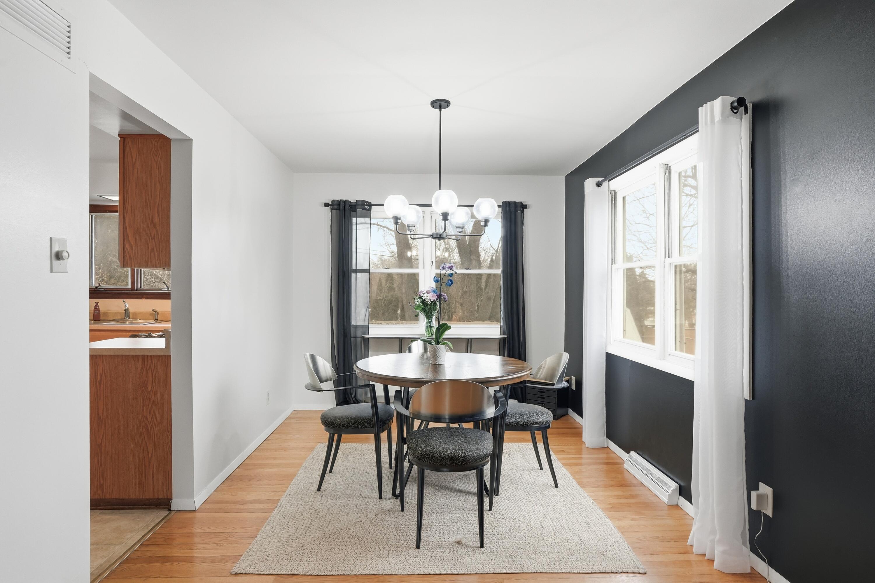 508 West 117th Place Crown Point, IN 46307 - Photo 6 of 20 a dining room with furniture a chandelier and wooden floor