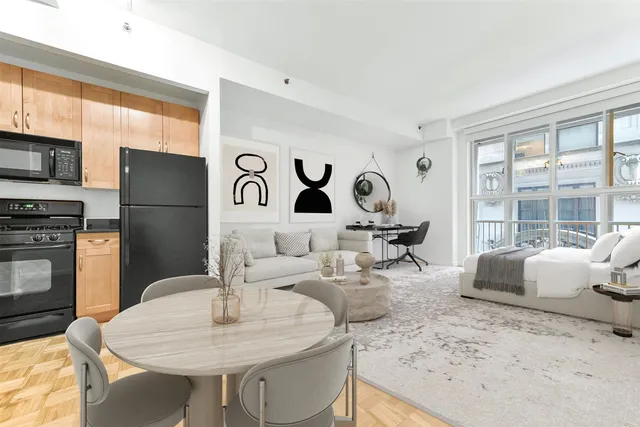 a living room with granite countertop furniture a fireplace and kitchen view