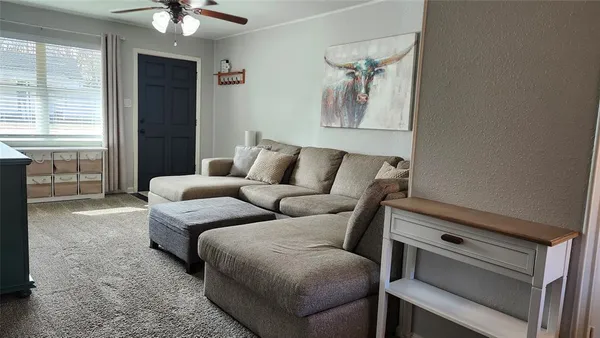 a living room with furniture and wall paintings
