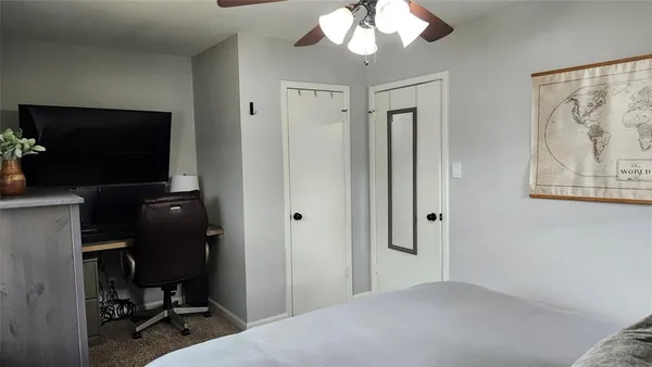 a bedroom with bed and tv