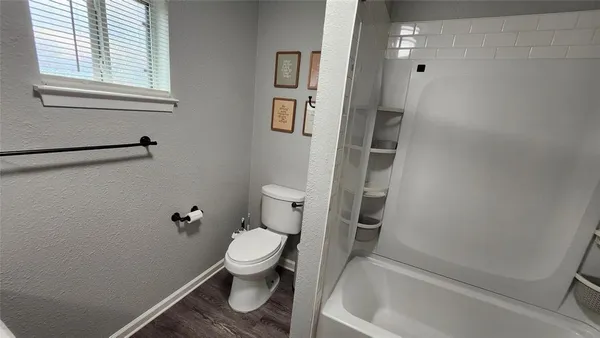 a bathroom with a toilet and a tub