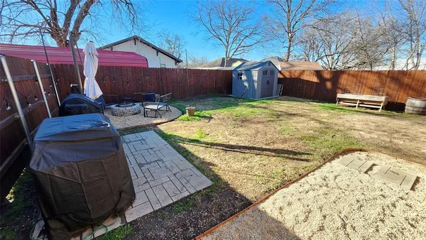 a view of a backyard with wooden fence
