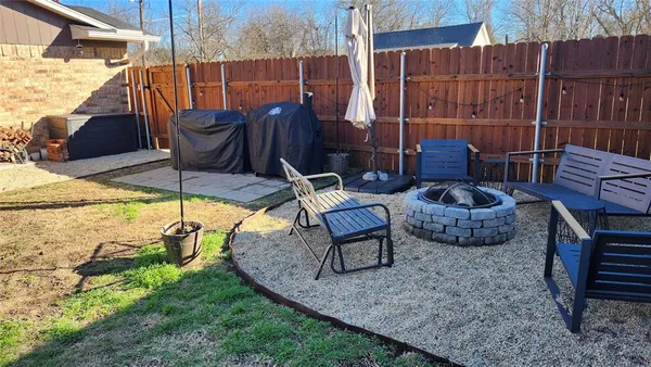 a view of a chairs and table in backyard