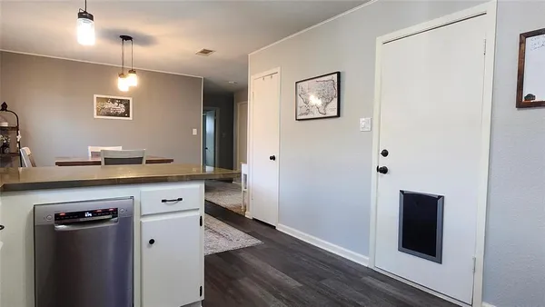 a kitchen with a refrigerator and a sink
