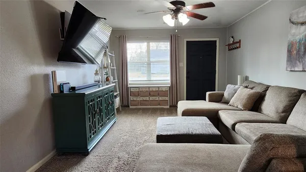 a living room with furniture and a flat screen tv